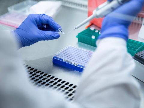 Scientist using a pipette in a lab