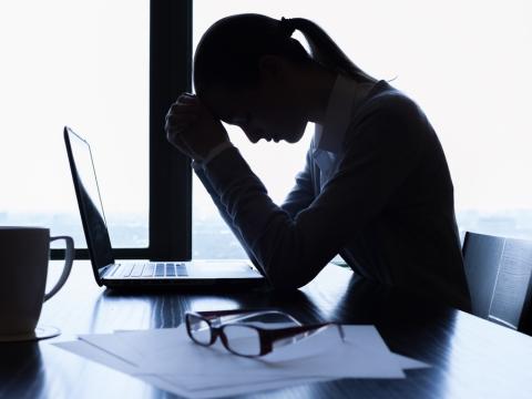 Silhouette of stressed businesswoman