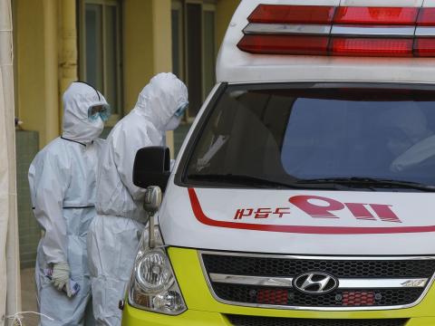 Healthcare workers outside ambulance
