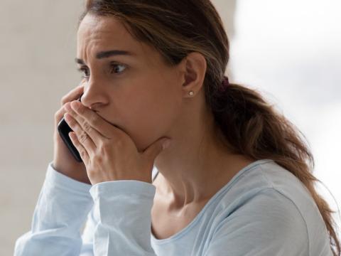 Stressed woman talking on phone