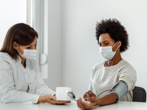 Taking woman's blood pressure
