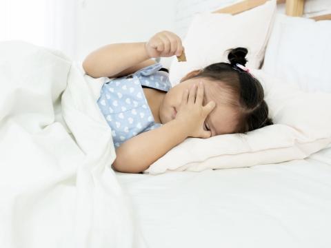 Tired little girl in bed