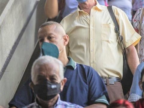 Train commuters inside station wearing masks