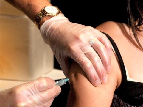 Vaccine syringe in arm