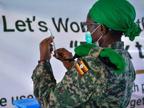 Vaccine worker with vial and syringe
