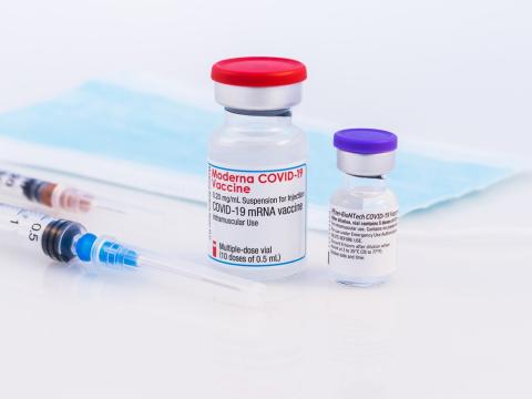 Vials of Moderna and Pfizer COVID vaccine side by side