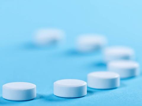 White pills blue background