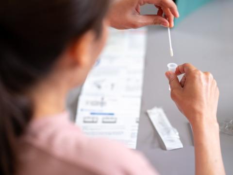 Woman conducting COVID-19 self-test