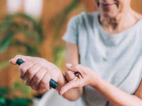 Woman monitoring her blood glucose