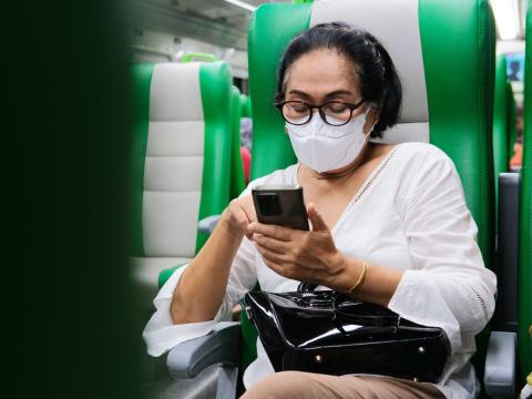 Woman on train wearing respirator