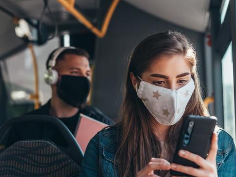 Woman wearing mask on bus