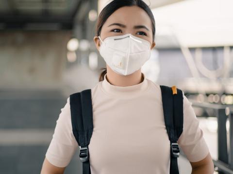 Woman wearing respirator in airport