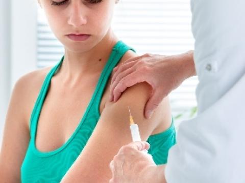 Young adult being vaccinated
