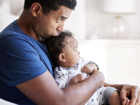 Young dad with baby on lap