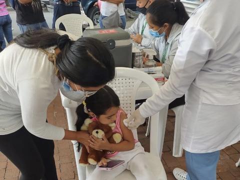 Young girl getting COVID vaccine in Colombia