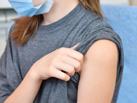 Young girl with sleeve rolled up ready for vaccine
