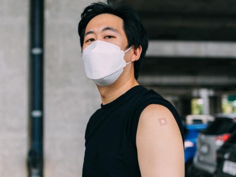 Young man with vaccine bandage