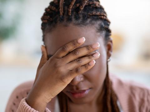 Young woman with long covid headache