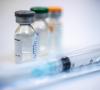 Three vaccine vials and syringe