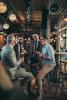 4 men drinking beer in bar