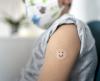 5-year-old boy with smiley-faced vaccine bandage