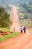 Travelers along African dirt road