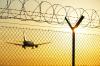 Passenger airplane behind fence