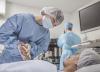 Asian surgeon with patient