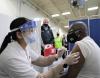 Bald man getting COVID vaccine