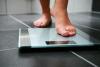 Bare feet stepping onto scale