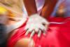 Gloved hands performing CPR