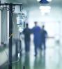 Blurry health workers in hallway