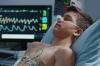 Boy in hospital bed with heart monitor