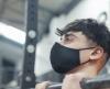 Boy wearing mask lifting weights