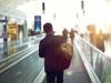 Businessman on airport moving sidewalk