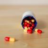 Capsules spilling from bottle onto table
