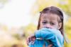 Child coughing into sleeve