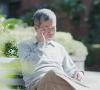 Confused older man on park bench