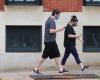 Couple wearing masks walking on street