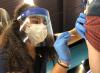 COVID vaccine needle going into arm