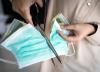 Woman cutting mask in two