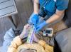 Caregiver instructing older man on daily drug regimen