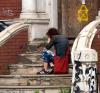 Distressed person on steps of dilapidated building