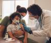 Doc prepping young boy for COVID vaccine