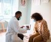 Doctor with patient, both wearing masks