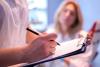Doctor writing in patient's chart
