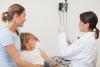 Doctor preparing flu shot for child