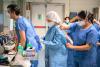 Hospital workers donning PPE