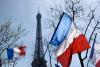 French flags in front of Eiffel Tower