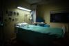 Empty bed in dark hospital room